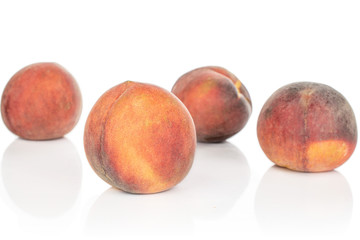 Group of four whole ripe sweet red peach isolated on white background