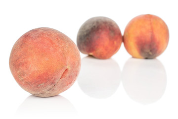 Group of three whole sweet red peach isolated on white background