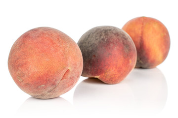 Group of three whole sweet red peach isolated on white background