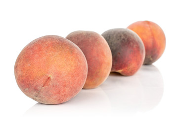 Group of four whole sweet red peach in diagonal isolated on white background