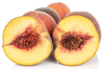 Group of four whole two halves of sweet red peach isolated on white background