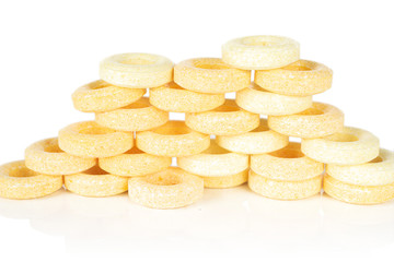 Lot of whole round pale yellow candy isolated on white background