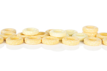 Lot of whole round pale yellow candy isolated on white background