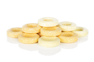 Lot of whole round pale yellow candy pyramid isolated on white background