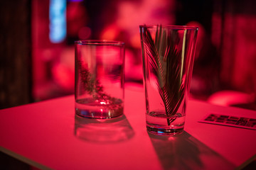 Glasses in club with red filled light