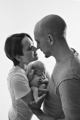 family photo on a white background: parents spend time with their children. mom and dad hug the baby. the concept of childhood, fatherhood, motherhood, IVF
