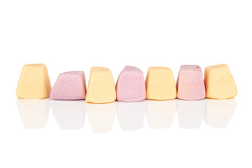 Group of seven whole soft pastel candy isolated on white background