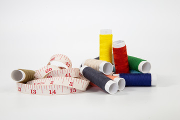 Sewing tools collection. thread sewing needle centimeter scissors on a white background.