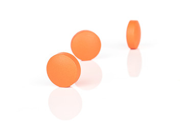 Group of three whole orange tablet pharmacy isolated on white background
