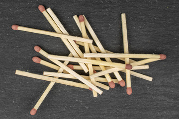 Lot of whole brown safety match flatlay on grey stone