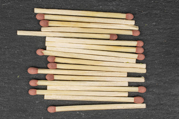 Lot of whole brown safety match flatlay on grey stone
