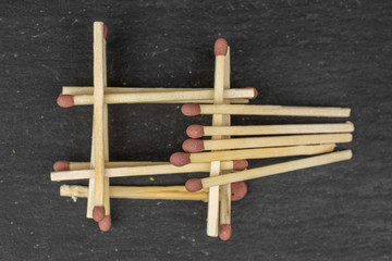 Lot of whole brown safety match tower flatlay on grey stone