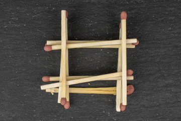 Lot of whole wooden brown safety match tower flatlay on grey stone