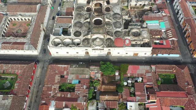 Aerial Drone view of Antigua in Guatemala. Flying forward over Unesco protected Catedral de Santiago destroyed by earthquake and Antigua main square Parque Central. 