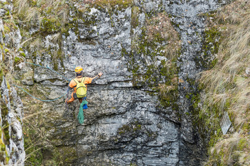 Fototapeta premium Sumgan-Kutuk karst cave. Cavers descend into the cave.