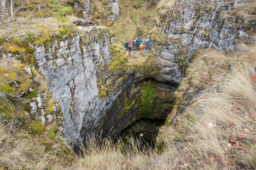 Sumgan-Kutuk karst cave. Cavers descend into the cave.