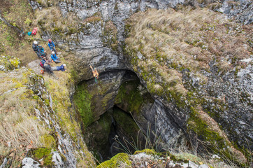 Sumgan-Kutuk karst cave. Cavers descend into the cave.