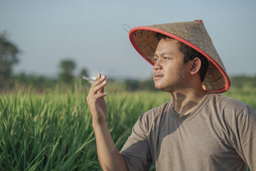 Close up photo of exhausted farmers in the rice field