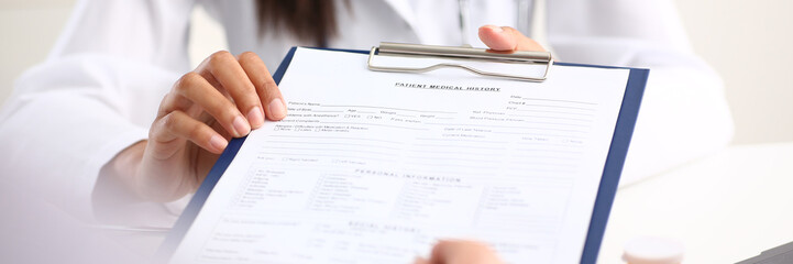 Female doctor hand hold silver pen and showing