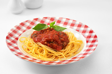 close up view of plate with spaghetti on white background.