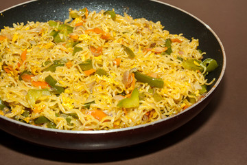 Closeup of egg noodles in a frying pan