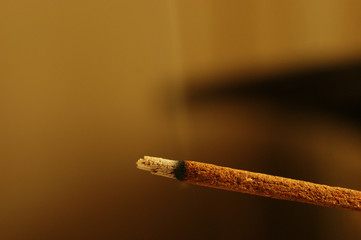 Incense stick burning with smoke, close up, macro.