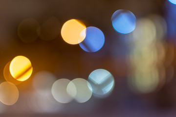Abstract multicolored bokeh balls floating across a dark background