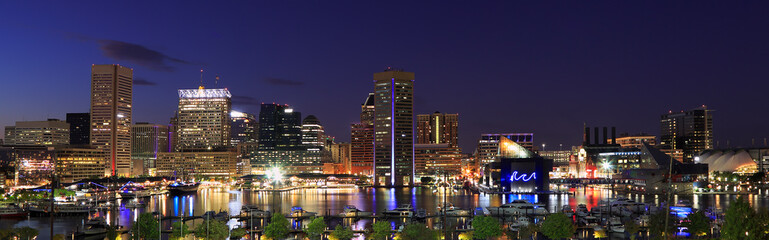 Colorful Baltimore skyline over the Inner Harbor at dusk