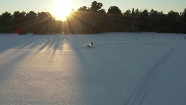 Aerial View Snowmobile Stunting In Winter Landscape Sunset