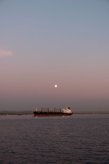 Moon over a cargo ship