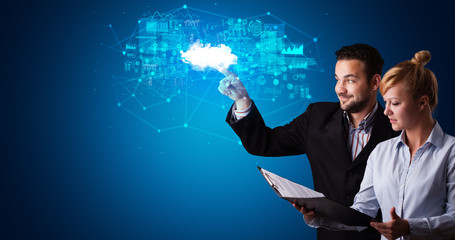 Man and woman touching hologram projection displaying information from cloud based system