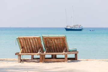 Two wooden sunbeds on the beach by the sea on island Koh Kood,Thailand