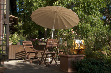 Seating group with parasol by Tuscan villa, region of Florence