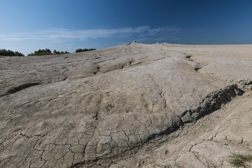 Drought scenery in summer, with very dry conditions and cracks in the soil in Europe, on a clear, cloudless day