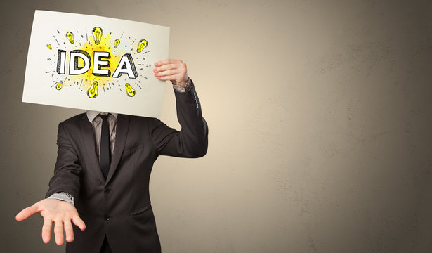 Young person holding white paper with new idea concept in front of his head