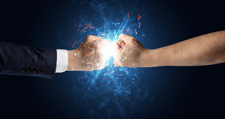 Fototapeta na wymiar Two hands fighting with light, glow, spark and smoke concept