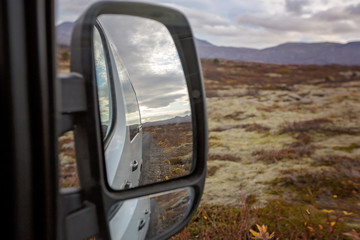 Reflection in car mirror of scenic Thingvellir National Park rift valley, Iceland