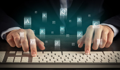 Business woman typing on keyboard with letters around