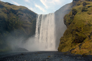 Beautiful view of the Skogafoss waterfall in Iceland on a sunset cloudy day