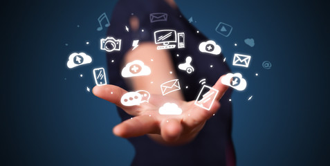 Hand holding application icons and symbols in her hand