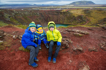 Children, boys, posing in front of Kerid crater lake in Iceland © Tomsickova