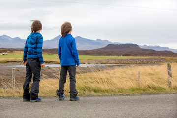 Children, playing on a road near non active vulcano in Snaefellsjokull National Park