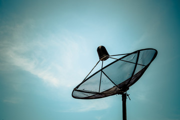 Old satellite dish on blue sky