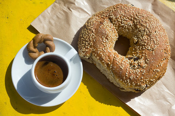 Greek breakfast, a cup of greek coffee whit sesame bread ring Koulouri. Taken in Naxos