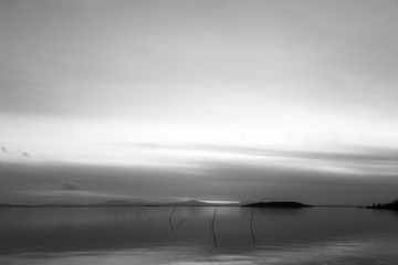 Sunset at Trasimeno lake (Umbria, Italy), with fishing net poles