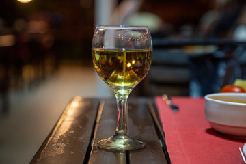 glass of white wine on wooden table