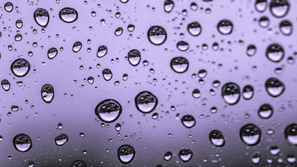 water or rain droplets on glass window. selective focus. narrow depth of field