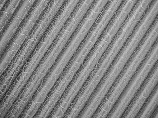 Abstract black and white tone background and closeup of diagonal striped or wave pattern with cracked surface texture.
