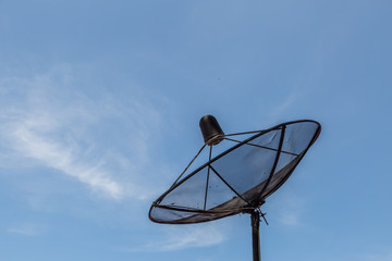 Old satellite dish on blue sky
