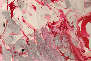 This a photograph of a Red,White,and Gray abstract marbleized design created using nail polish